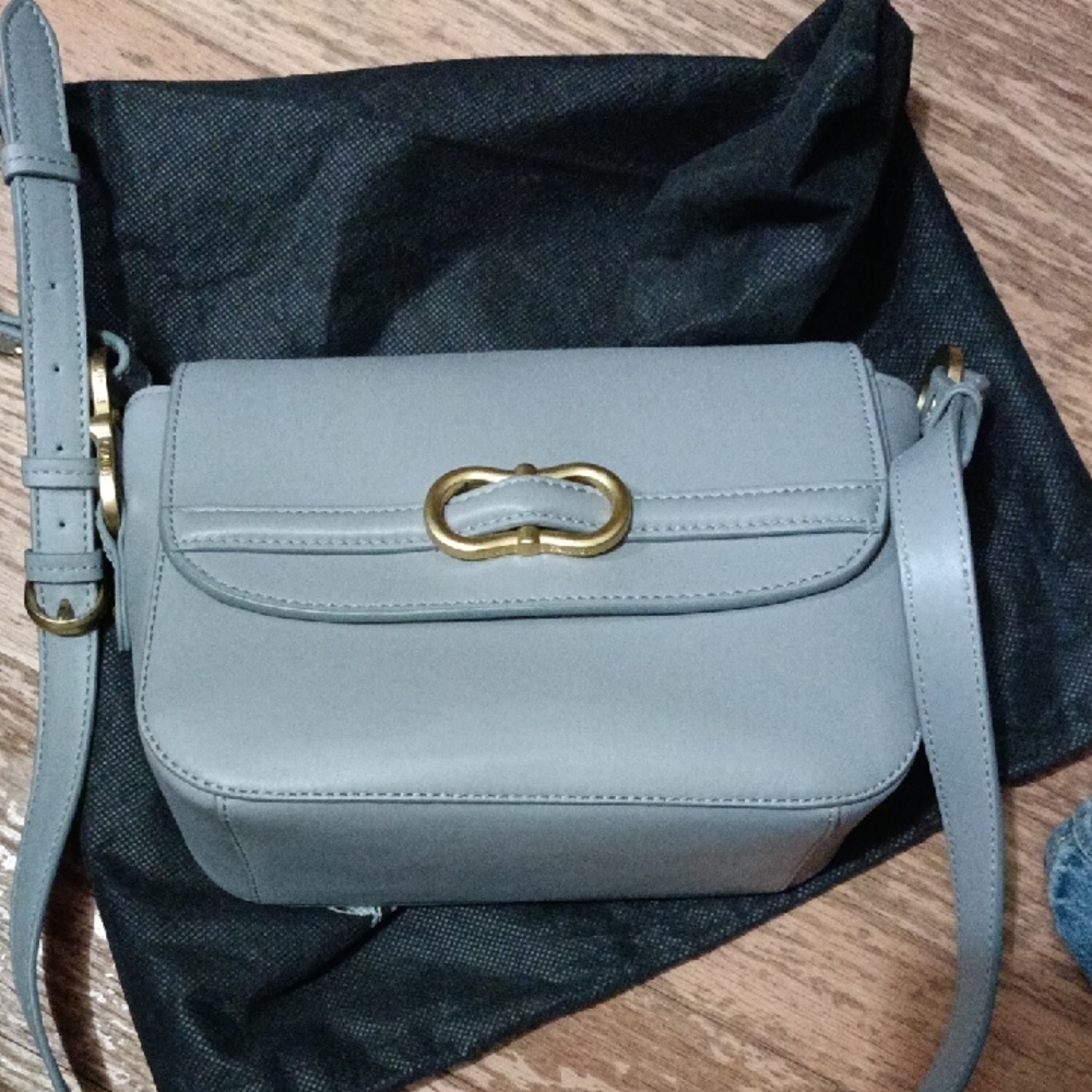 Vince Camuto Letta In The Color Light Fog Crossbody Bag with Gold Accent.